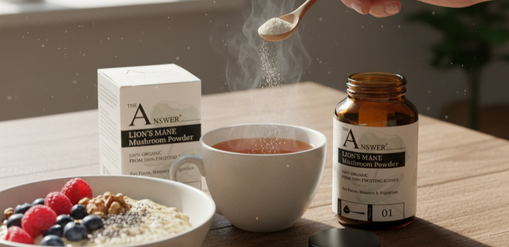 Person adding powder to tea with Answer Lion's Mane Mushroom Powder packaging on a table.